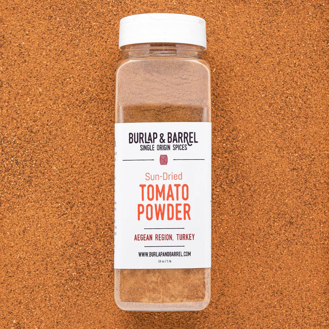 Bottle of Burlap & Barrel sun-dried tomato powder on a brown background