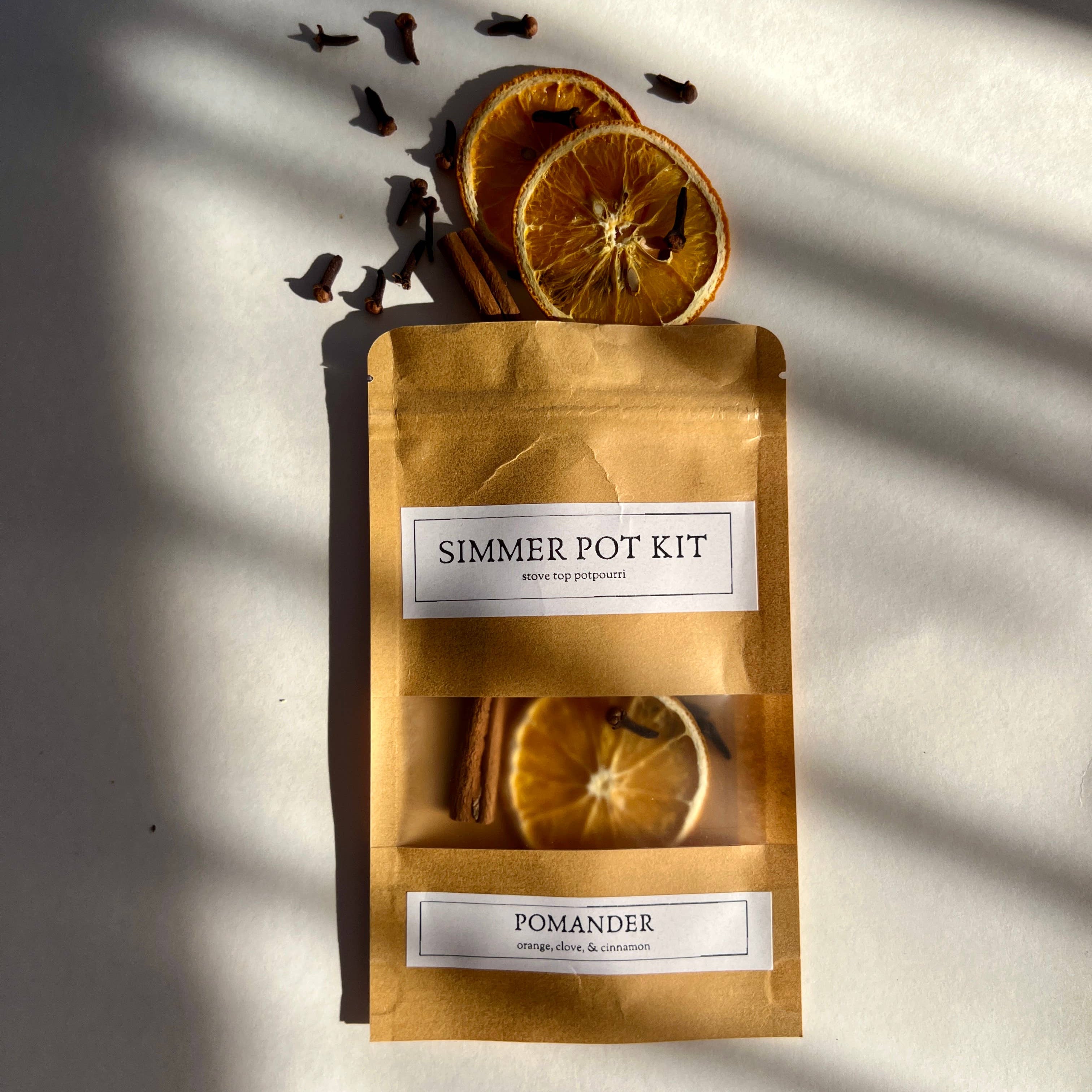 Simmer pot kit with pomander slices on a light background