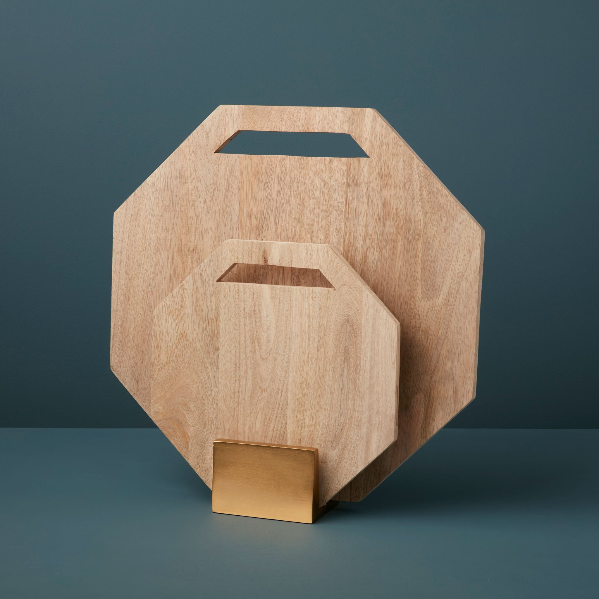 Two wooden hexagonal boards on a gold stand
