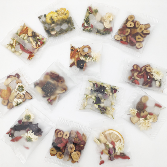 Assorted dried fruit and flower packages arranged in a circular pattern on a white background