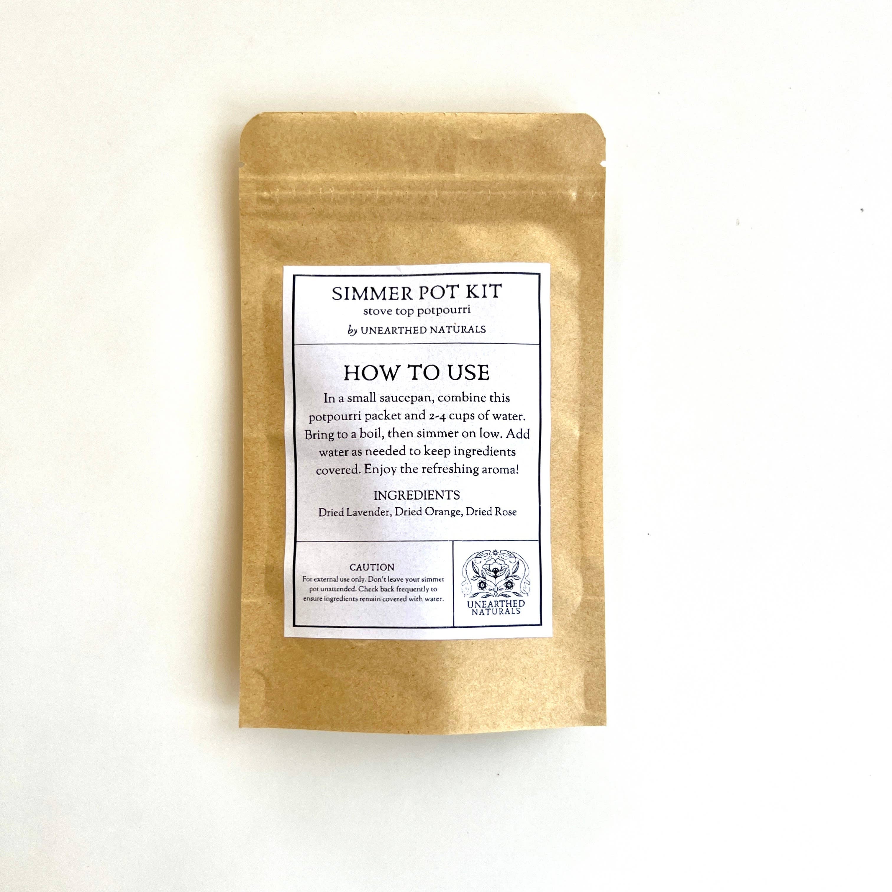 Gold packaging of a simmer pot kit with a label on a white background