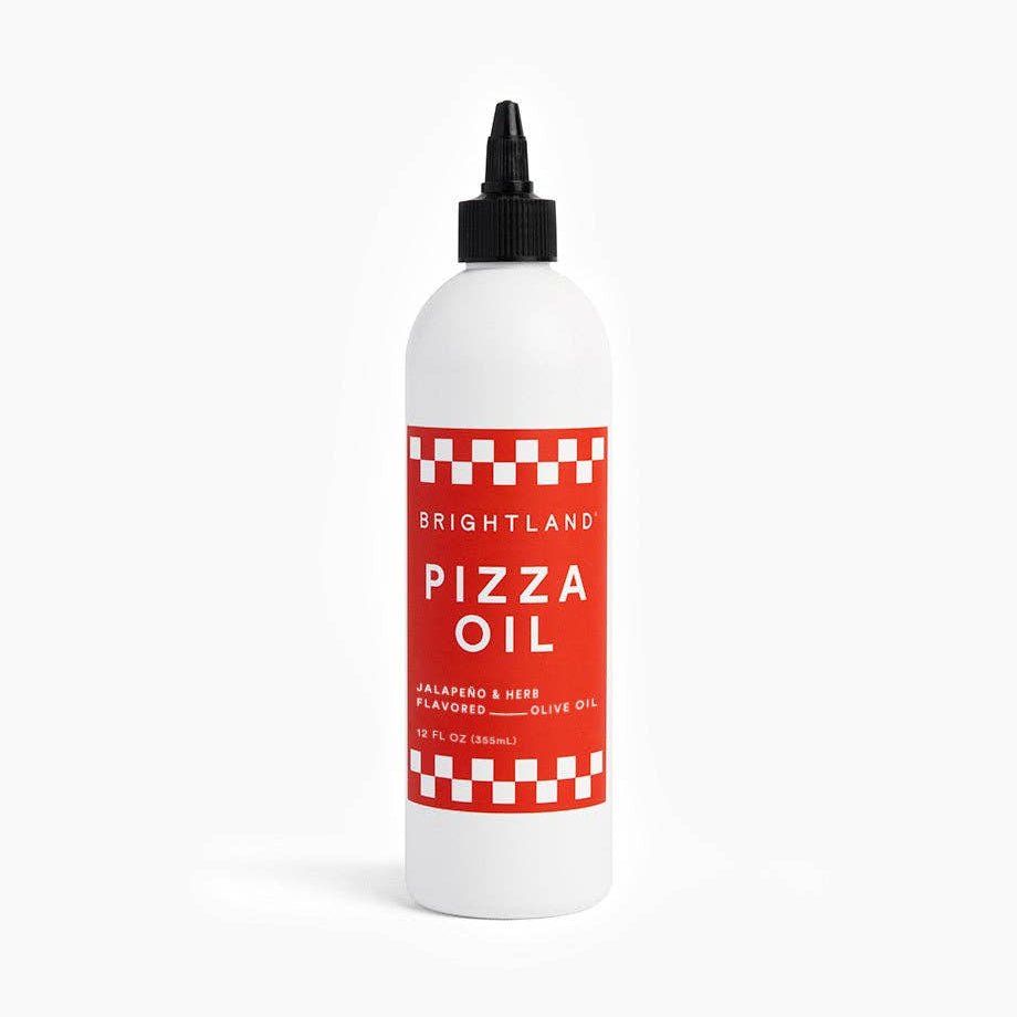 Bottle of Brightland Pizza Oil on a white background