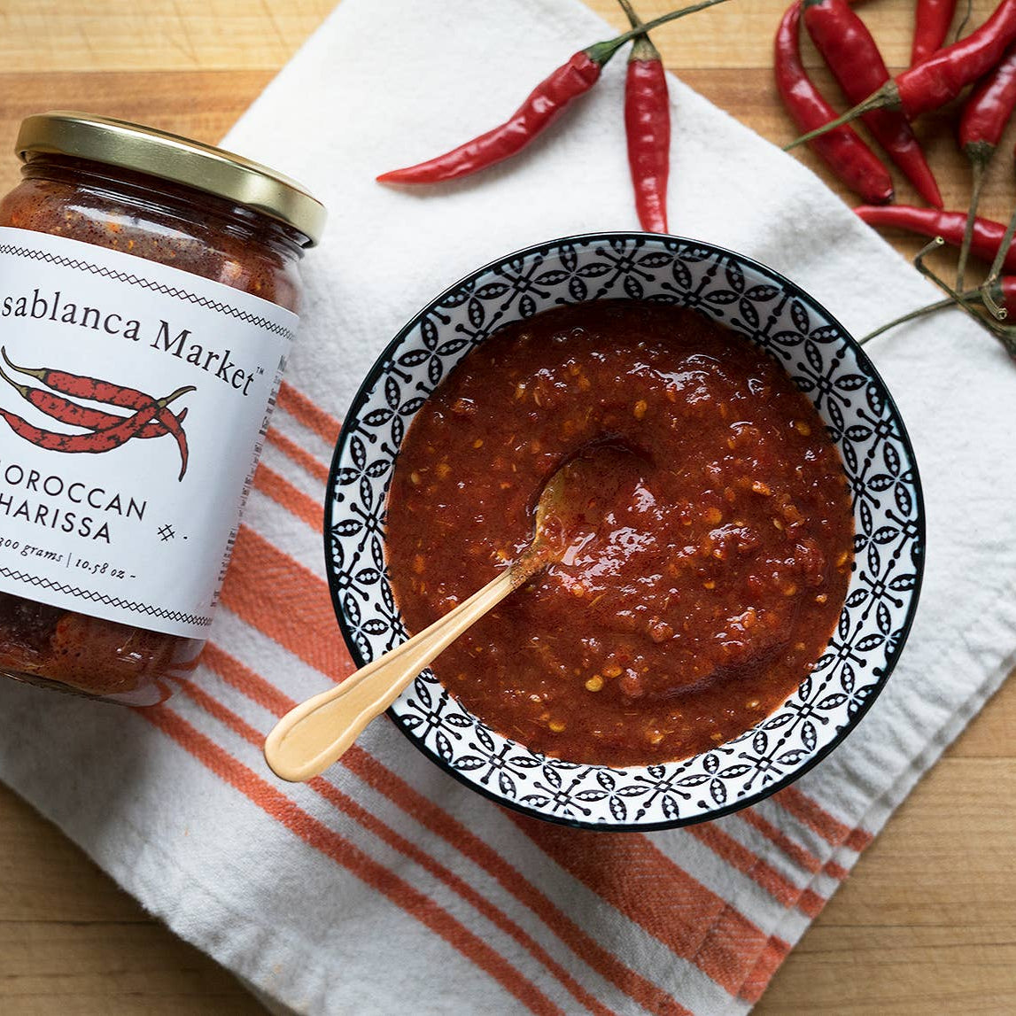 Casablanca Market Moroccan Harissa jar and bowl with harissa on a wooden surface