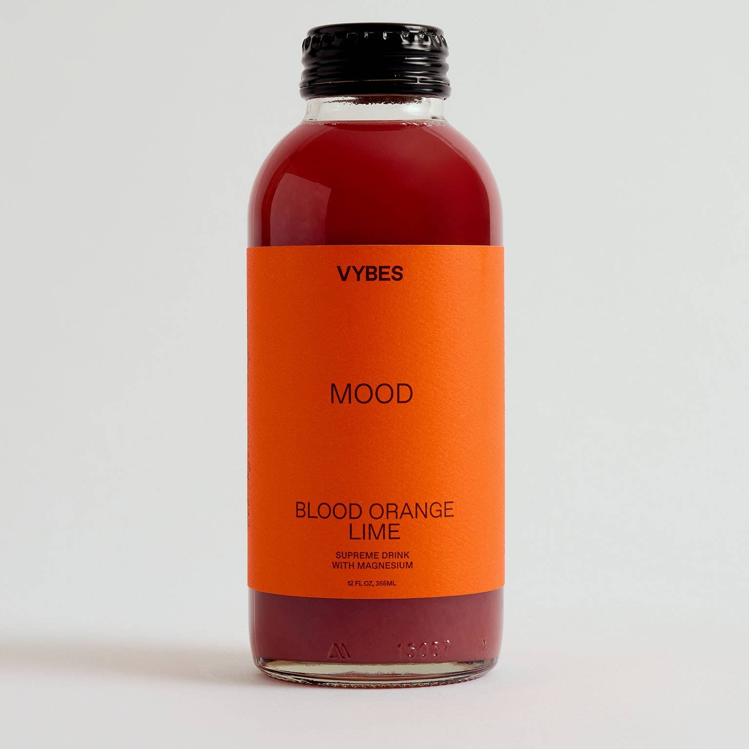 Bottle of VYBES Blood Orange Lime on a white background
