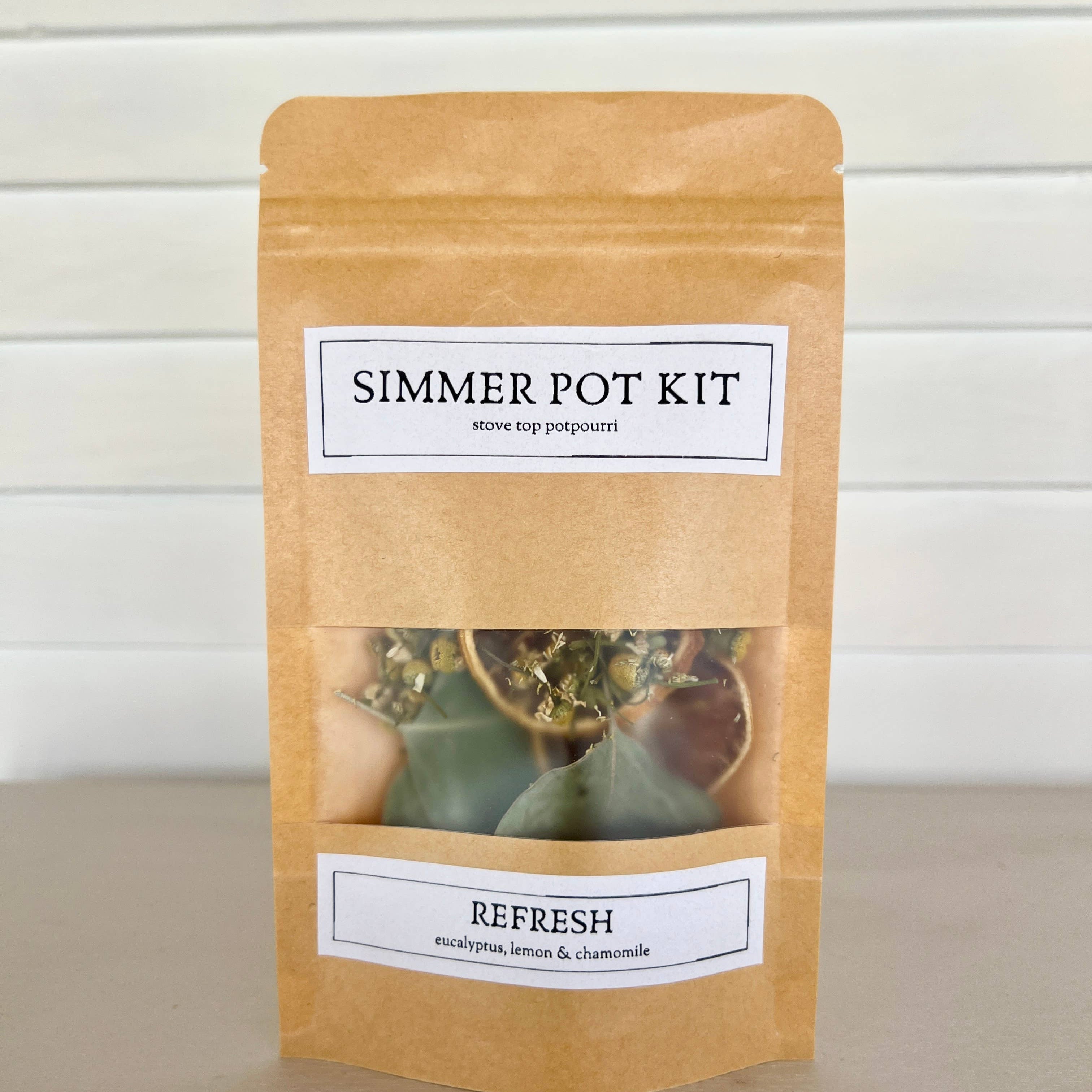 Simmer pot kit packaging with text and images on a neutral background
