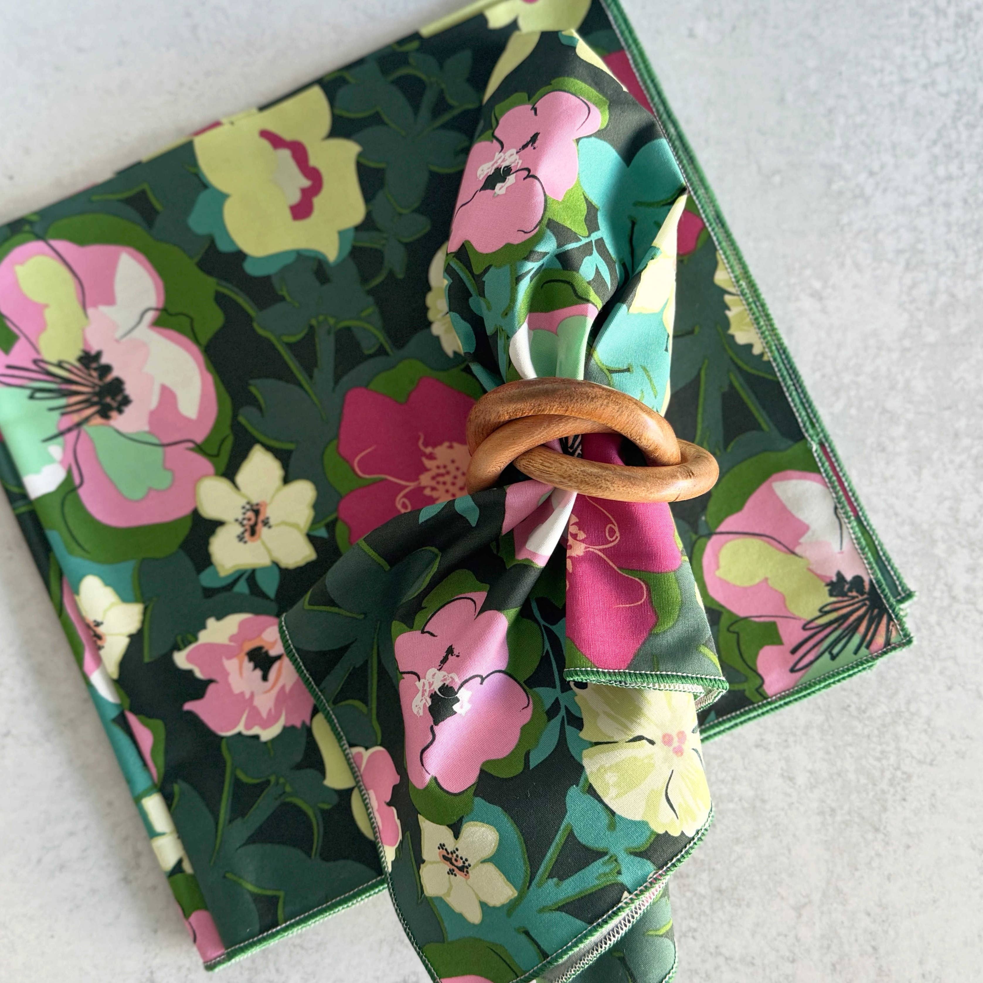 Floral-patterned fabric with a wooden ring on a white background