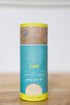 Container of lime cocktail rimming salt on a wooden surface