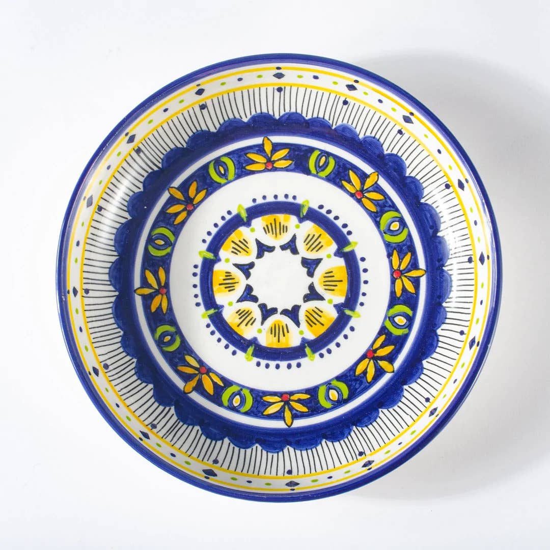 Decorative plate with blue, yellow, and white pattern on a white background