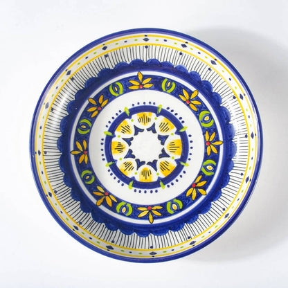 Decorative plate with blue, yellow, and white pattern on a white background