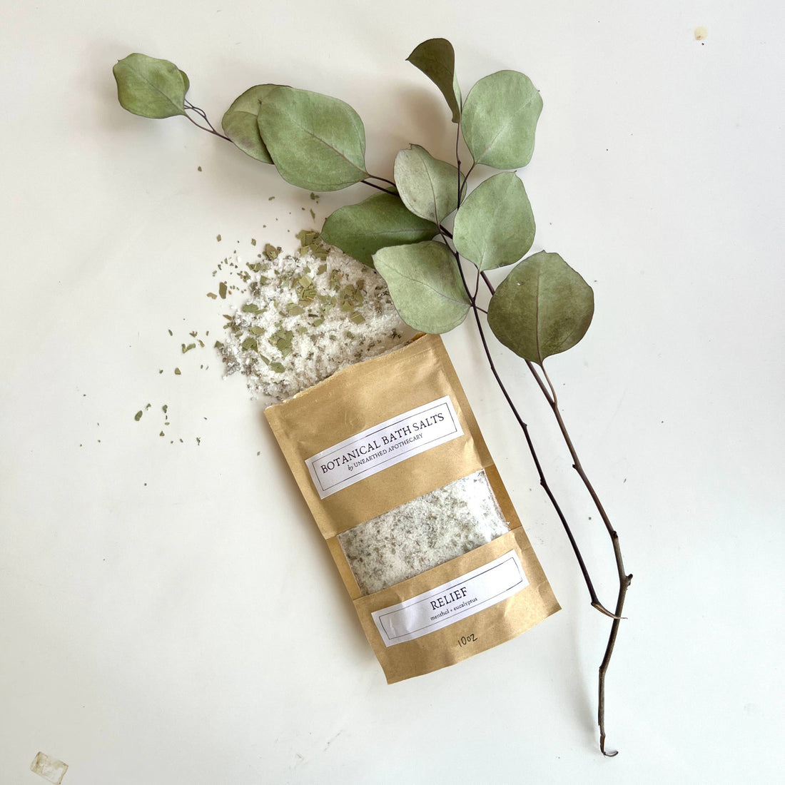 Bag of botanical bath salts with eucalyptus leaves on a white background