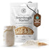 Sourdough starter package with a jar of starter and organic ingredients on a white background