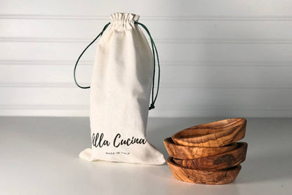 A stack of 4 Italian Olivewood Aperitivo Bowls next to a drawstring bag