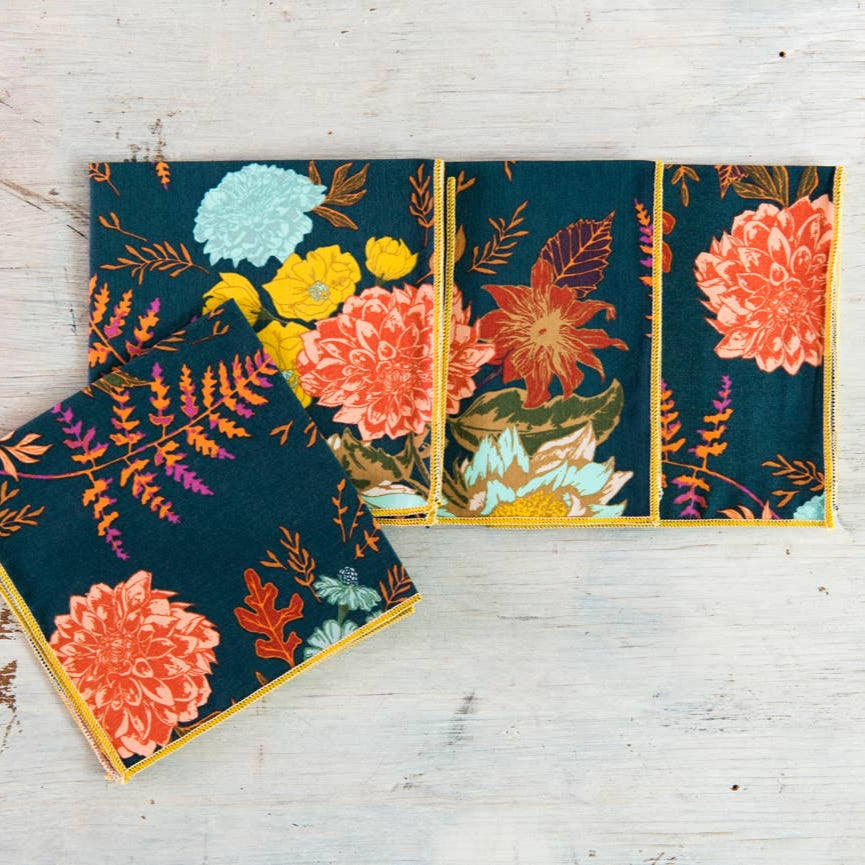 Floral-patterned notebooks on a wooden surface