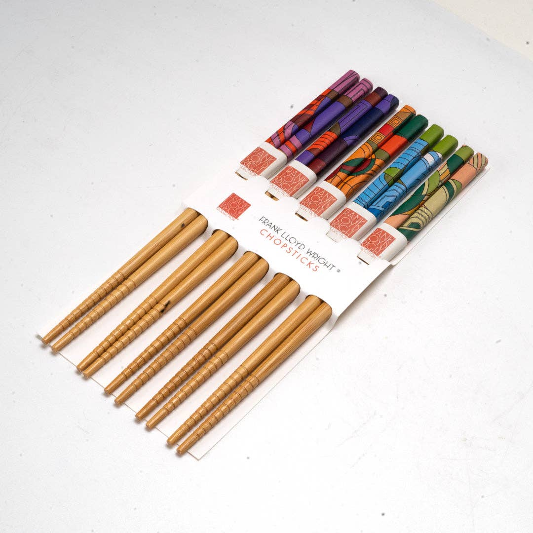 Set of wooden chopsticks with colorful packaging on a white background