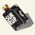 A bottle of SURRUP brand brown sugar simple syrup with a black label and gold cap, photographed on a light beige background with a soft shadow.