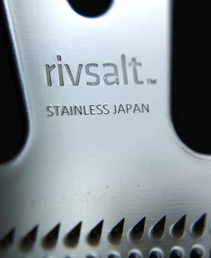 Close-up of a rivsalt stainless steel grater