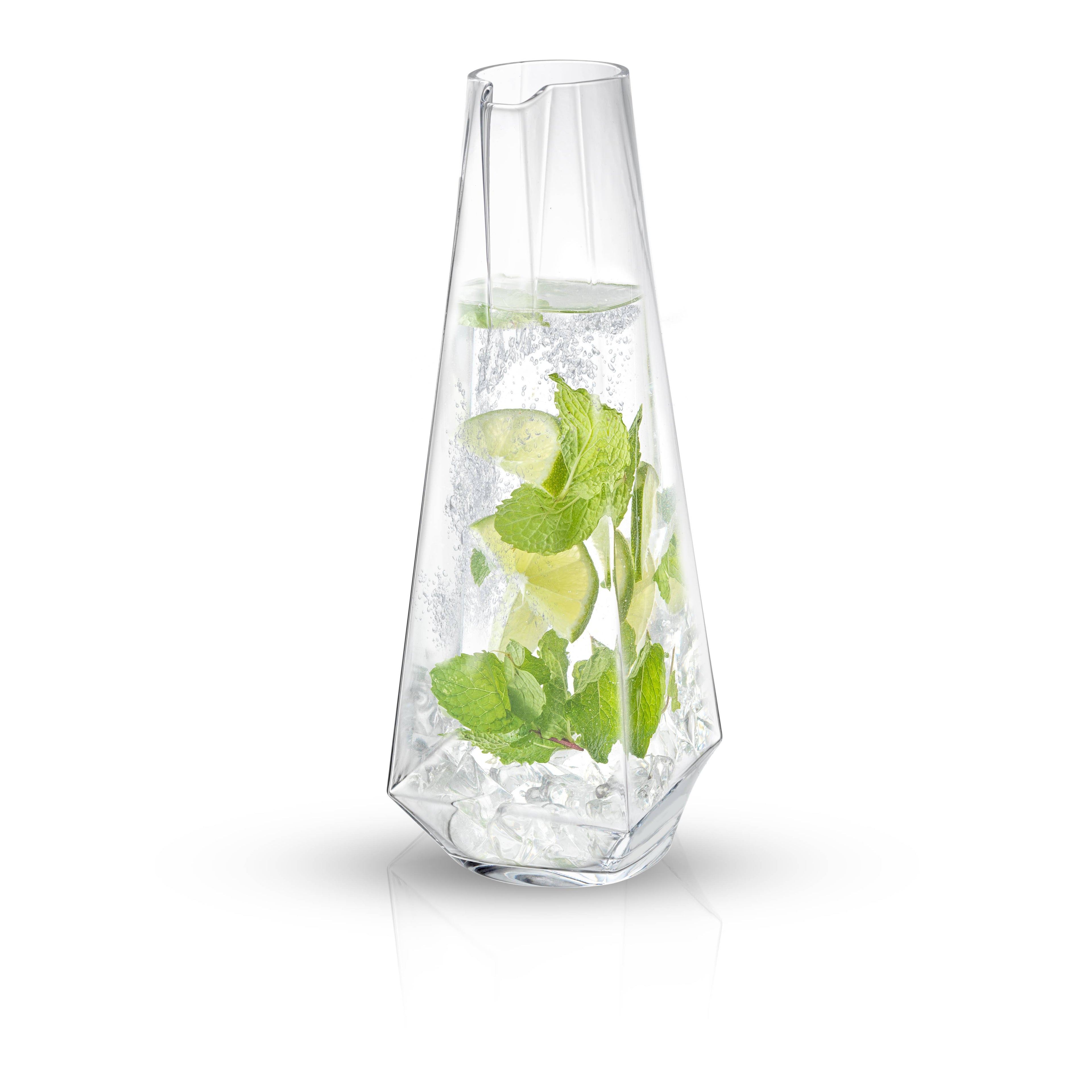 Clear glass vase with water and green leaves on a white background