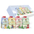 Monista Tea Christmas Tea House Collection gift set featuring four illustrated house-shaped tea boxes with red ribbons and a matching display box in the background, all on a white background.