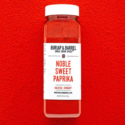 Container of Noble Sweet Paprika from Burlap &amp; Barrel on a red background