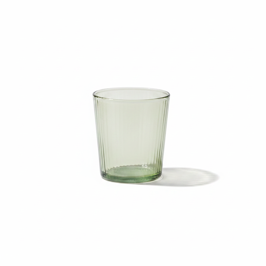 Short glass tumbler on a white background
