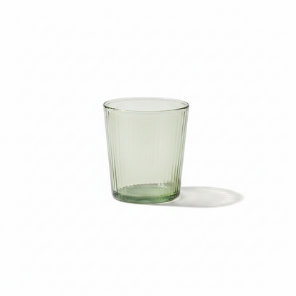 Short glass tumbler on a white background