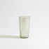 A tall glass tumbler, standing on a clean white background with a soft shadow to the left.