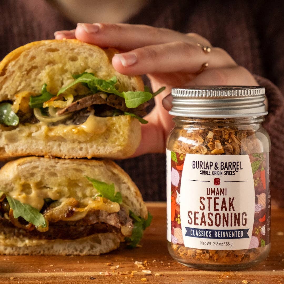 Burlap &amp; Barrel Umami Steak Seasoning jar with a sandwich in the background
