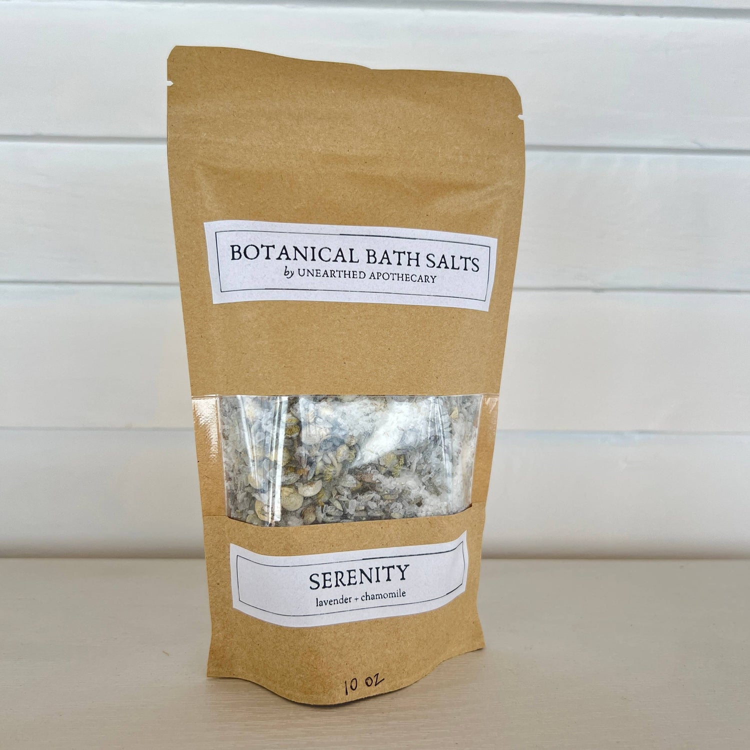 Kraft paper packaging of Botanical Bath Salts with a label on a white background