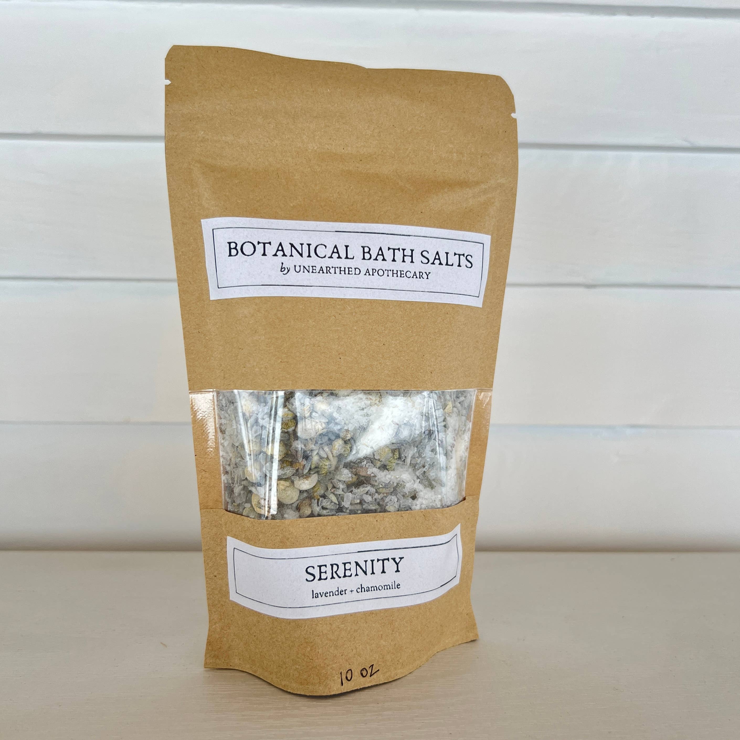 Kraft paper packaging of Botanical Bath Salts with a label on a white background