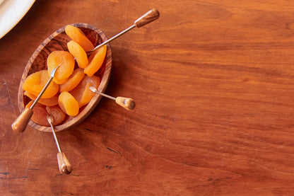 Italian Olivewood Aperitivo Bowl filled with dried apricots on skewers