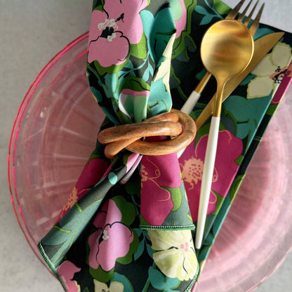 Floral napkin with cutlery on a pink plate