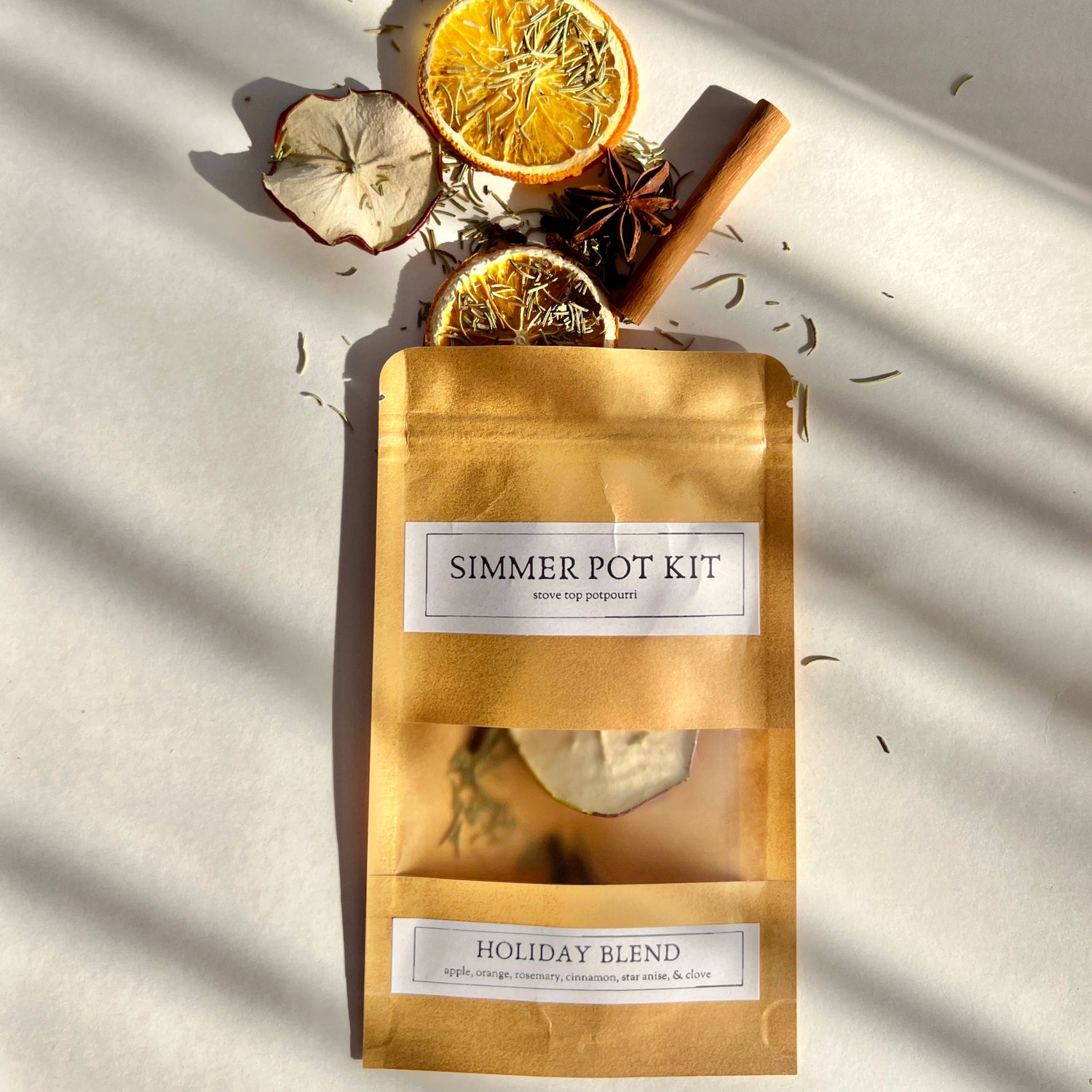 Simmer pot kit with dried oranges, cinnamon, and star anise on a light background