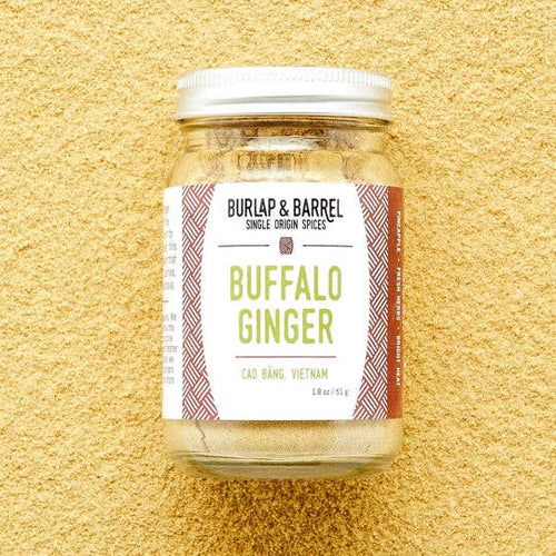 Jar of 'Buffalo Ginger' spice from Burlap & Barrel on a textured beige background