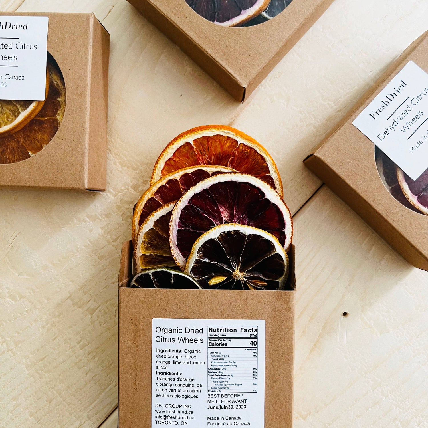 Box of organic dried citrus wheels with visible packaging on a wooden surface