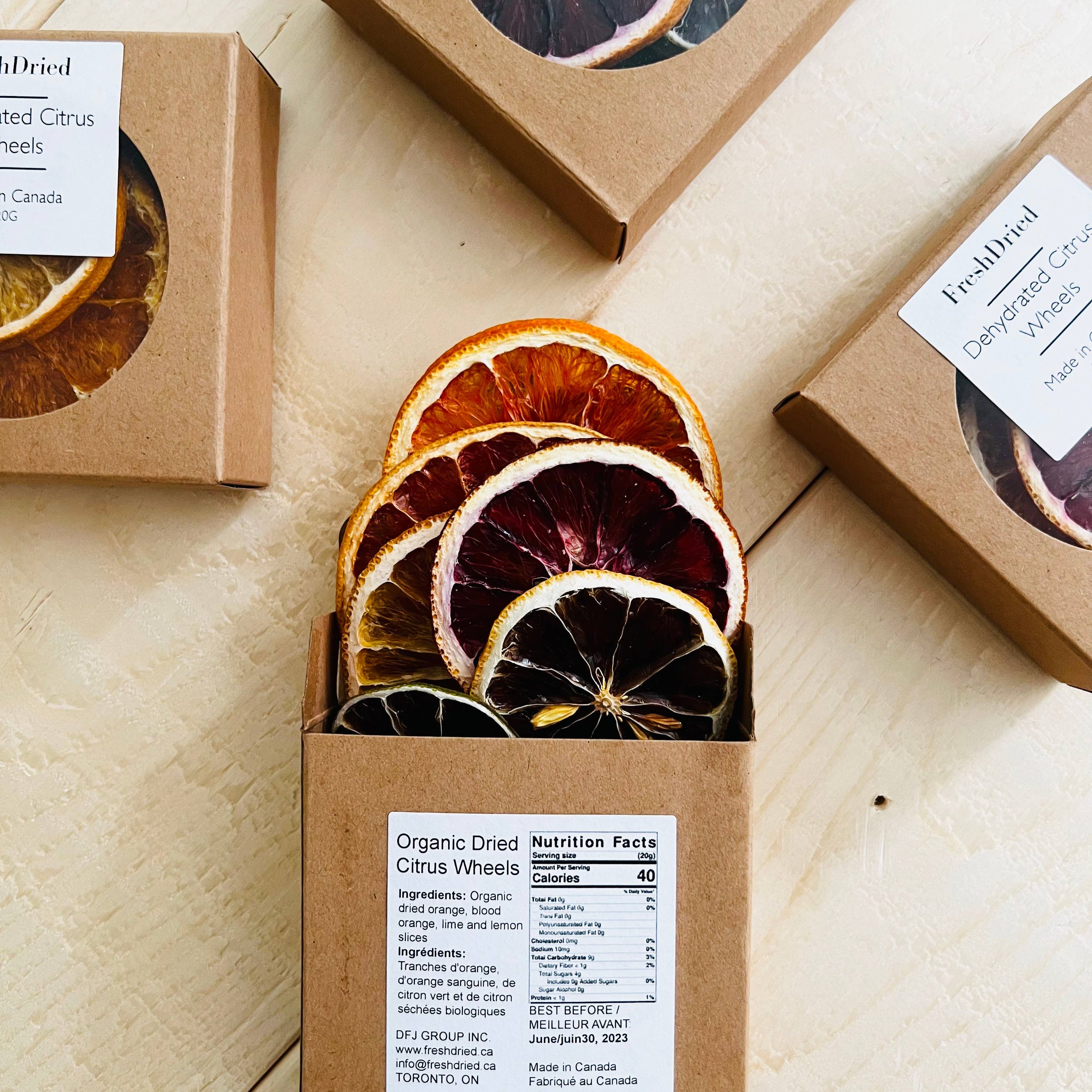 Box of organic dried citrus wheels with visible packaging on a wooden surface