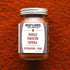 A glass jar of Burlap & Barrel Smoked Pimenton Paprika spices, set against a textured orange-red background.