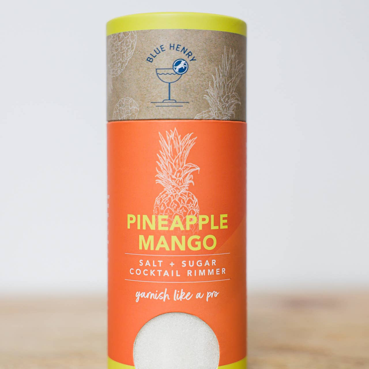 Pineapple Mango salt and sugar cocktail rimmer packaging on a wooden surface