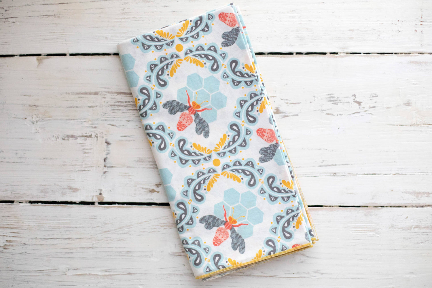 Honey bee napkins on a wooden surface