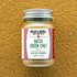 Jar of Burlap & Barrel Hatch Green Chili Powder on a textured brown background