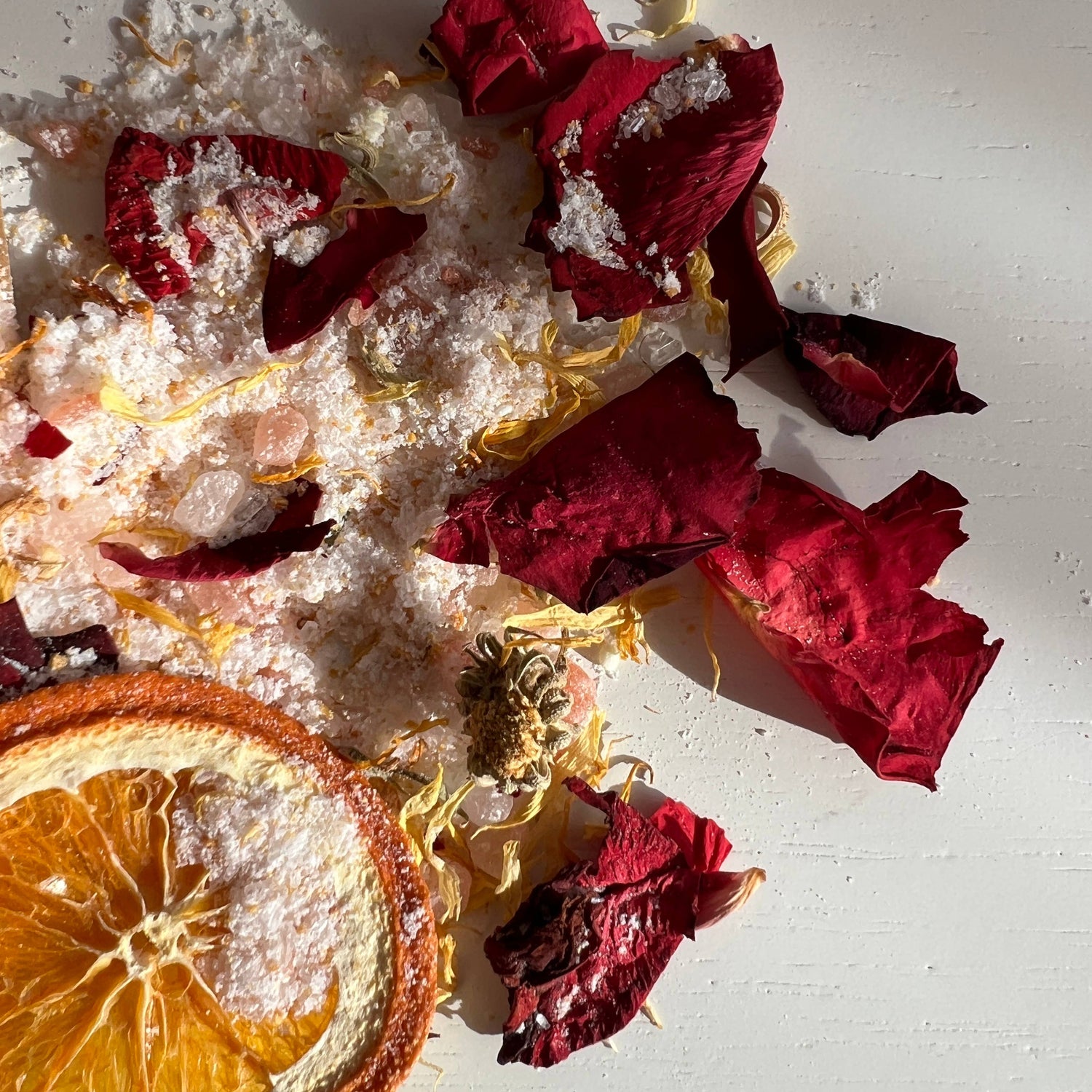Salad with dried orange slices and red leaves on a white background