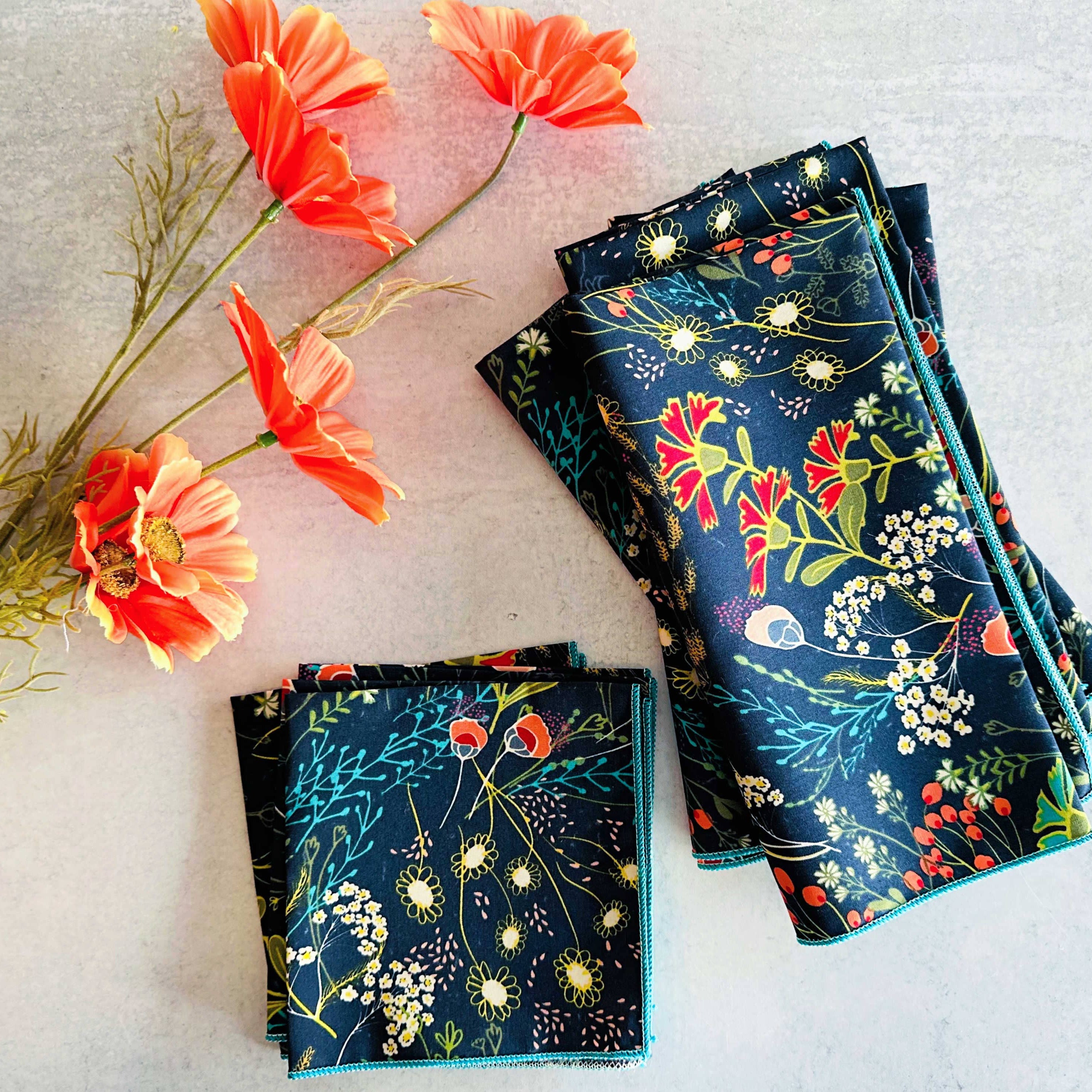 Folded floral-patterned fabric with orange flowers on a light background