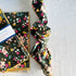 Floral patterned fabric with a visible brand label on a light gray background