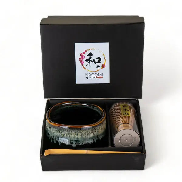 Ceramic tea set with a black box labeled &