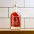 Bottle of Runamok maple syrup on a wooden surface with a white tiled wall background