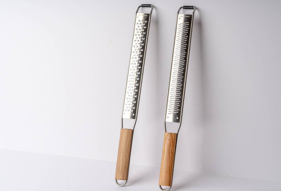 Set of coarse and fine Italian Mandolin Paddle Graters with wood handles on a white background