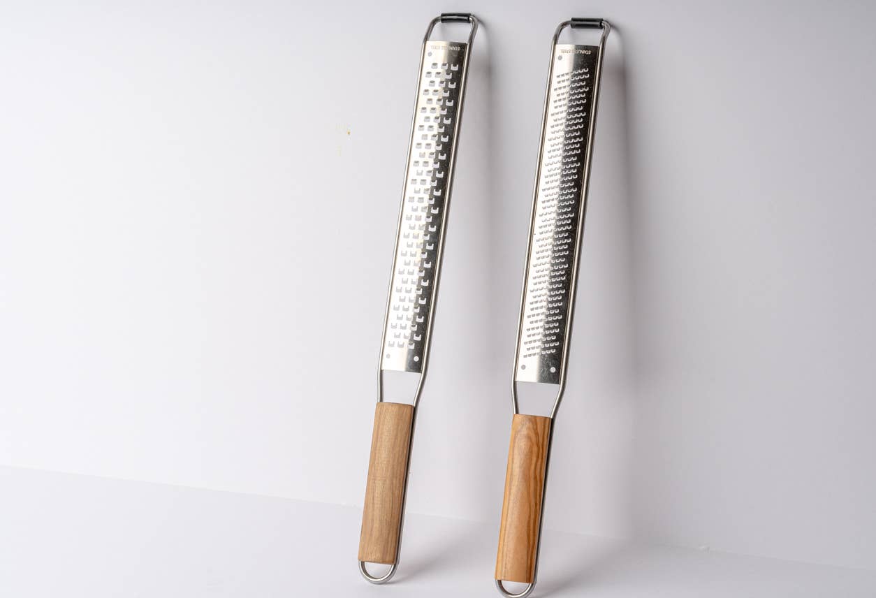 Set of coarse and fine Italian Mandolin Paddle Graters with wood handles on a white background