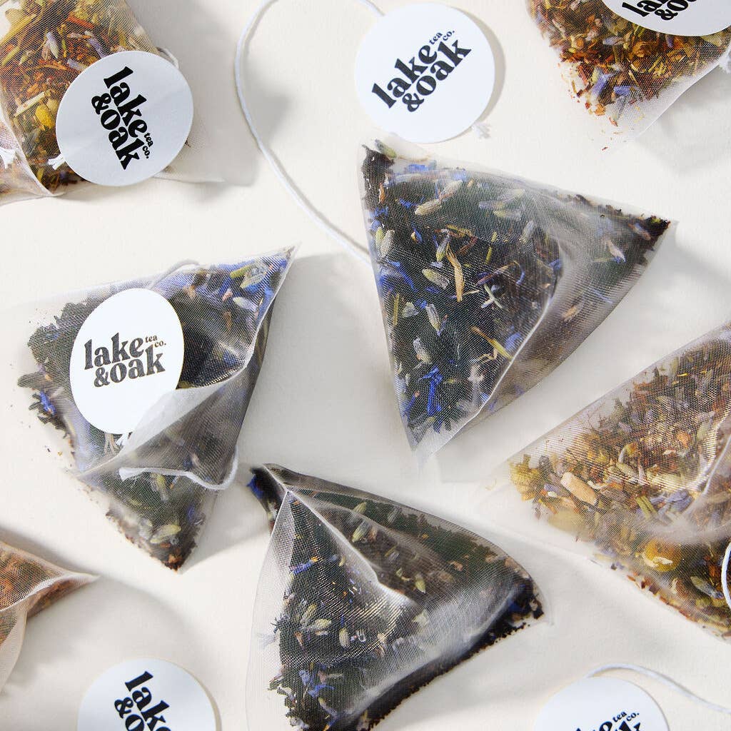 Triangular tea bags with visible herbs and &