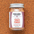 Jar of Burlap & Barrel Sun-Dried Tomato Powder on a textured brown background