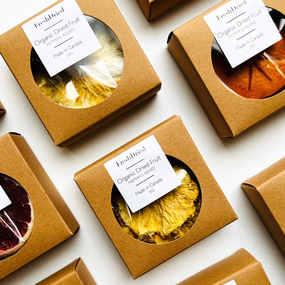 Packaged dried fruits with visible labels on a white background
