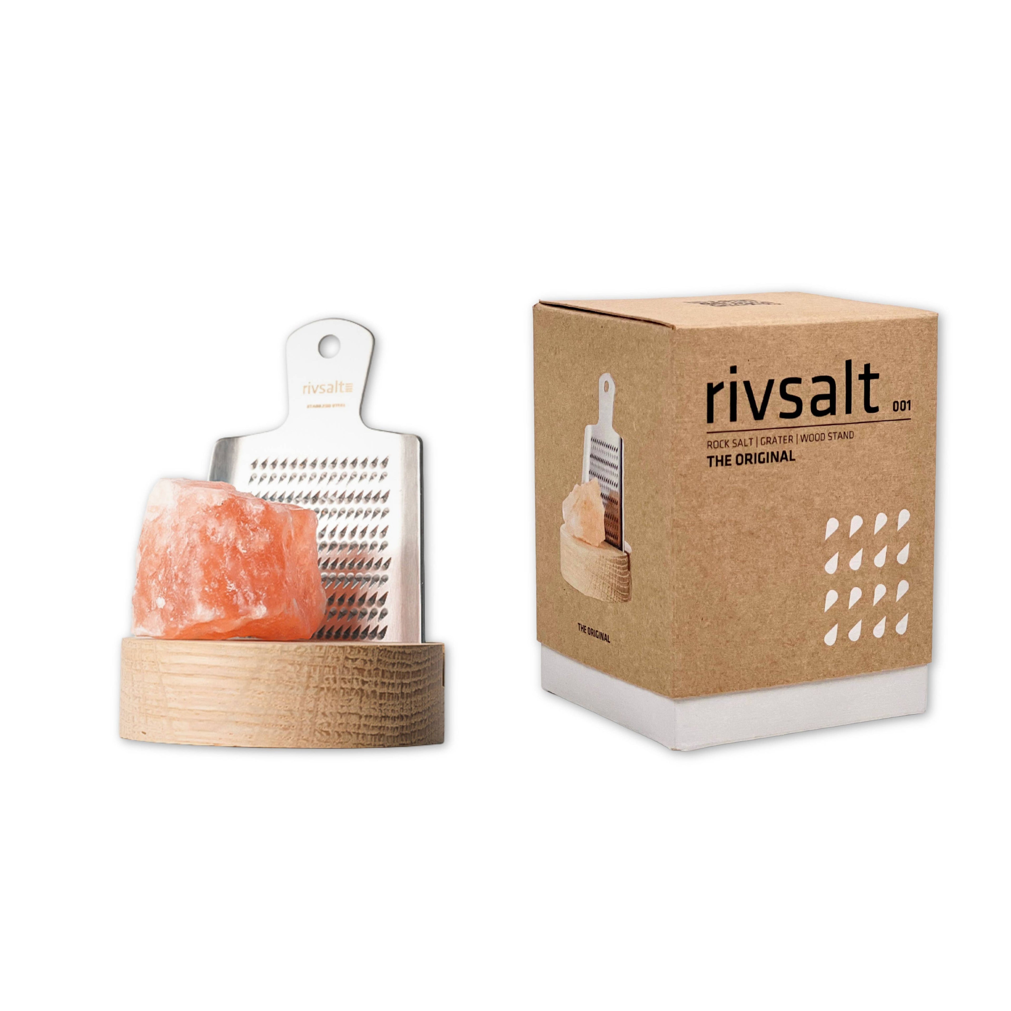 Himalayan salt lamp with grater and packaging on a white background